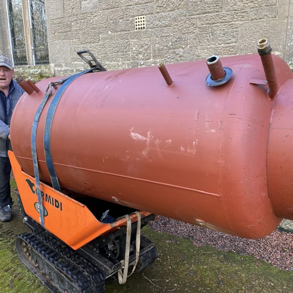 Stuart pulling out old buffer tanks along with a old log boiler