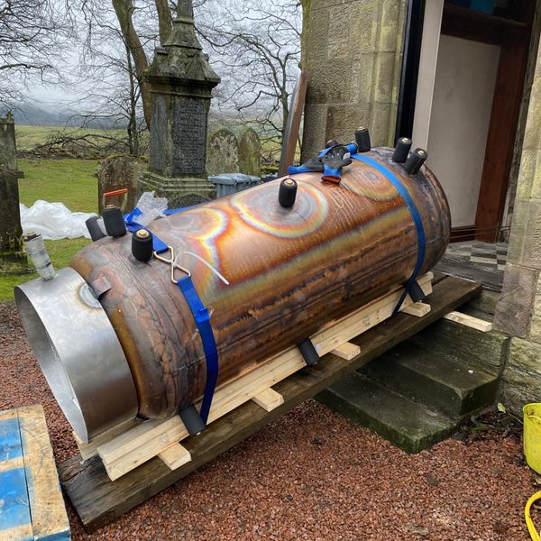 Thermal store getting winched into place through a door, Made to measure in this case, with the insulation and case to be fitted, when in place.