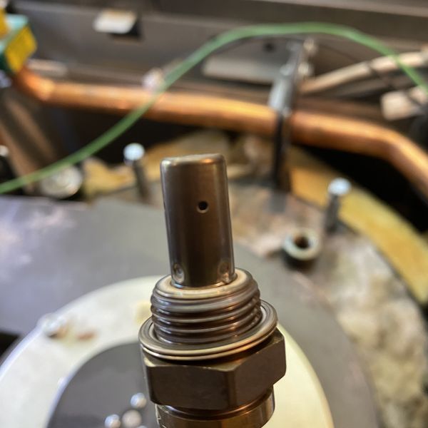 Lambda sensor, being cleaned . This optimises combustion by controlling fuel and air.